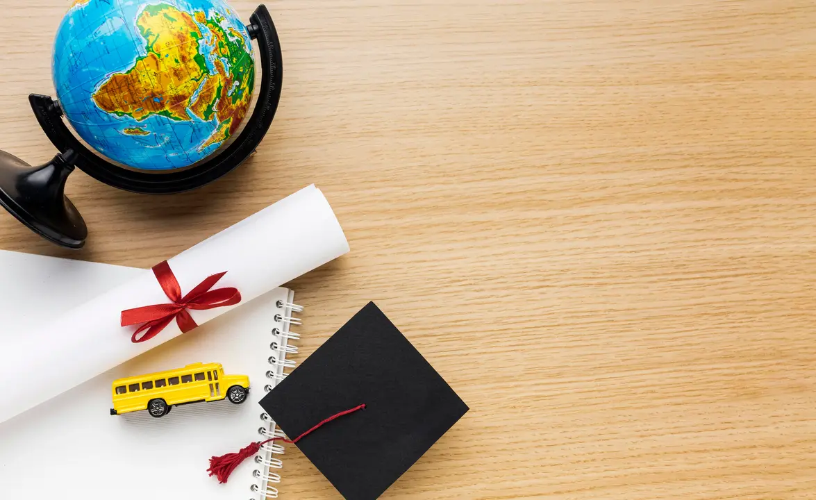 Academic cap with globe , college offer letter and bus depicting education loans for studies abroad.