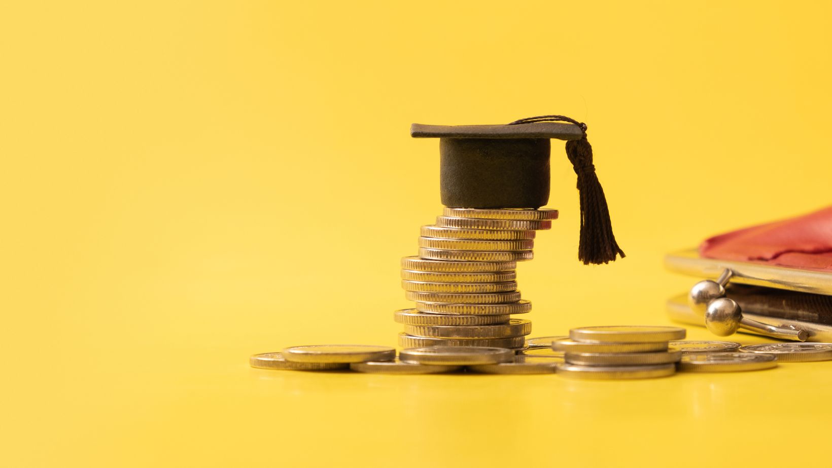 coins stacked with graduation cap for types of collateral loans for education