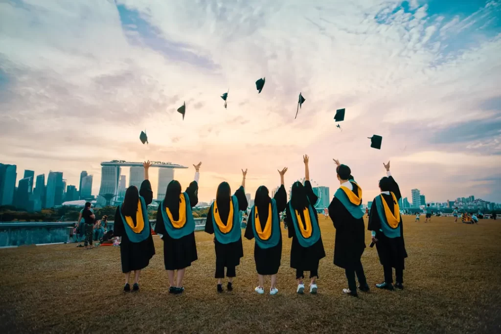 University students throwing their uni hats in the sky depicting Nanyang Technological University Scholarships