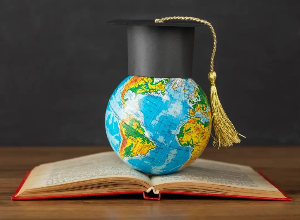 Graduation cap on earth globe depicting Tata scholarships for study abroad