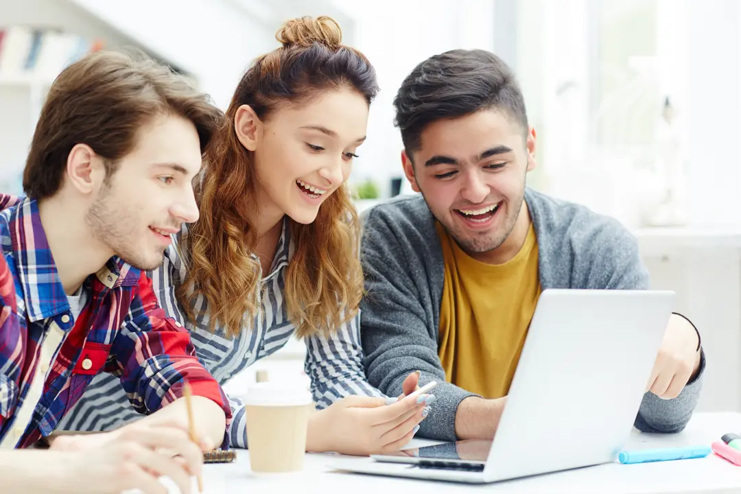 Indian students looking at the laptop to apply for fully funded MBA scholarships